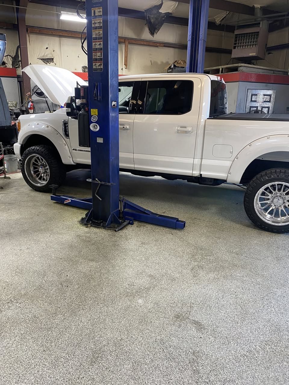Lifted Ford F-250 Super Duty diesel in the Whitty'z Diesel shop