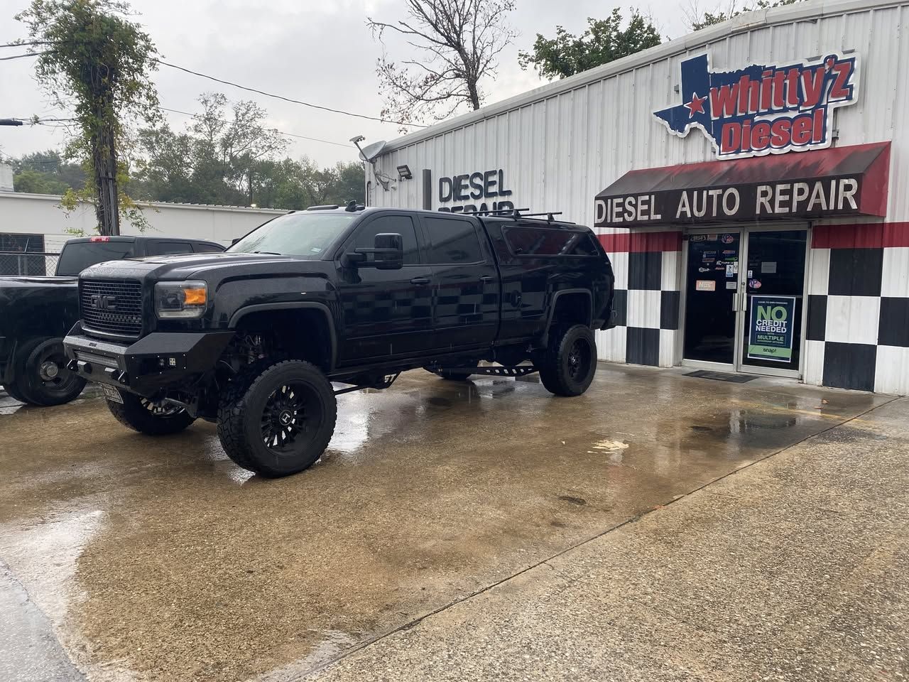 Whitty'z Diesel shop in Humble, TX with a lifted GMC Sierra 2500 diesel